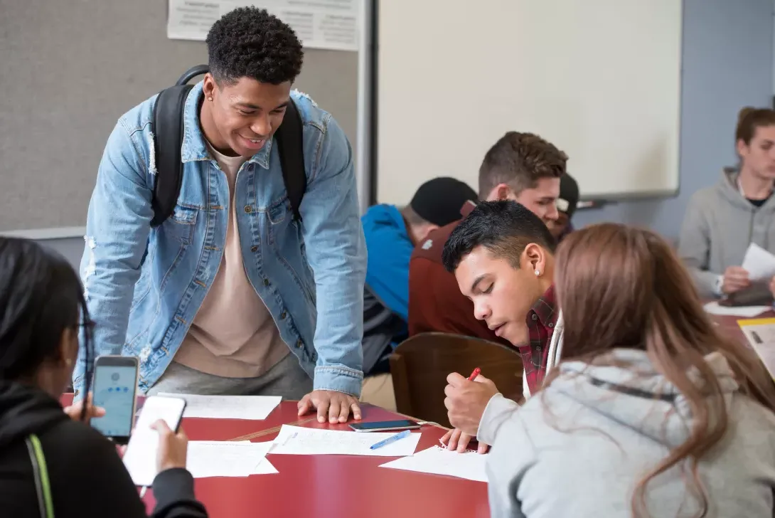 Students in classroom, reviewing notes